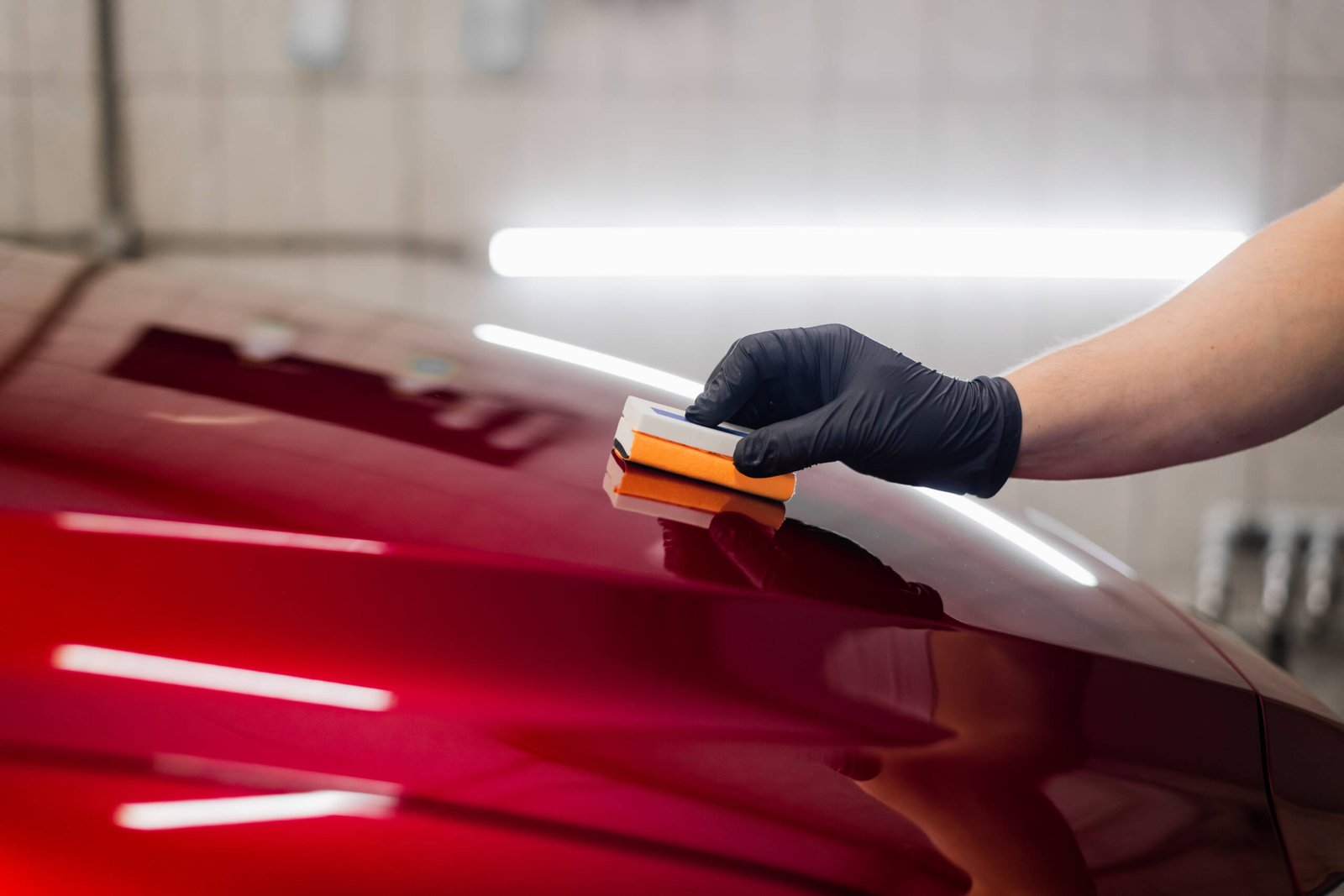 Man worker of car detailing studio applying ceramic coating on car paint with sponge applicator. SSUCv3H4sIAAAAAAAACnRSyY7cIBC9R8o/WJxjyfsy/zBSDrlFcyhwuY2aBotlkmjU/x4MZppkkhu8V/VebW+fPxUFoWA4I0/F2/Hzfy6EM1aD5Up6uPpy4hrlgjpHcOFWaQ4iBylYtkm4oQelE+KA74EkxoJ1Bk1mZjZnLWpjFbt6uE4qO/9pIQcov4SgfVNW5UTdtHo9gMyIgcWLr+wPq9Tn9/gvEhFIn+Ep8k2DNLvSNnZ/esRKHY0Rjl0NSUQ0/I/aV1S7wH+pPHPDUAiQqFwmFh8vqTW4oGS/Hi0cyhp9aa94A31Fm3dzjOJd6SU+7tlMNAqEOPwzh7RQj8O8TiU0Y1t20zyU89rRsh1bulDK6Mr6IBkrItcfflW3MNNTFNzCVTbjV8VAHAFt5rxrzri8ZGnKbuGSUhpTTlp9dErqsU8DI0KpHaif4FOxellM+AbG+Iwl4fnm/emqW2YllQ09k6hKFn8awadtumHoqmlo+66uhnk6A+KRbtzrhIpSjW4XChY8TB/r+Pt8h6qph7FqhvedPy45cnXfP7gPR33GjOm68/s+ubn7uNsgwpd8M/wolDCK01BVfYlN25TdOo/lhGtT+nanHhu2djP4Dd9/AwAA//8DANTBvMgKBAAA